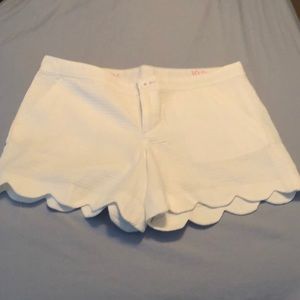 Lilly Pulitzer white shorts with scalloped edges.